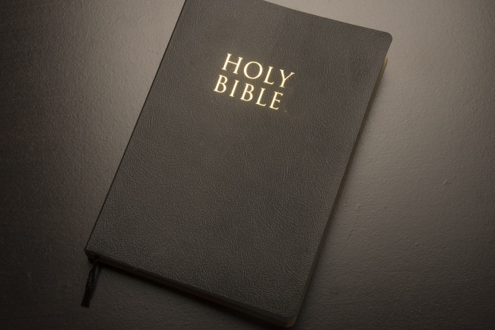 A Holy Bible laying on a table.