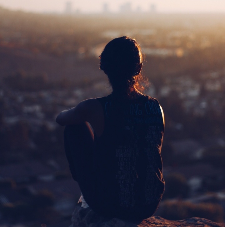 A young woman sitting by herself.