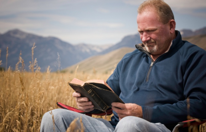 A man reading a Bible.