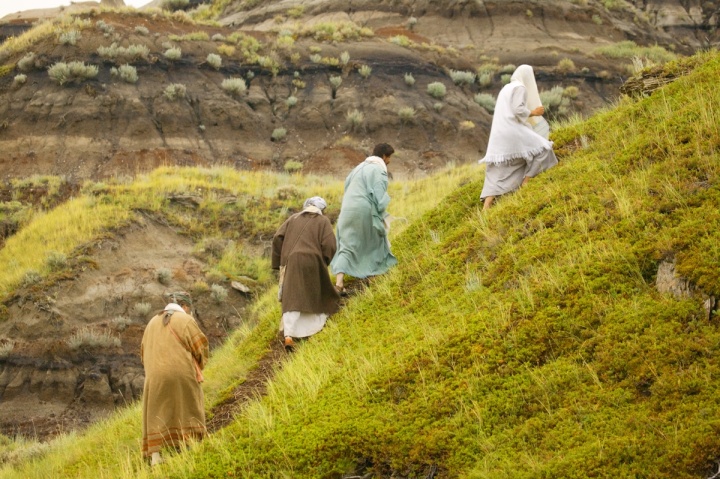 People walking up a hill.