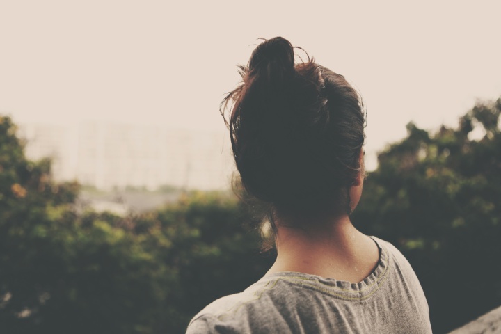 A woman looking over a valley.