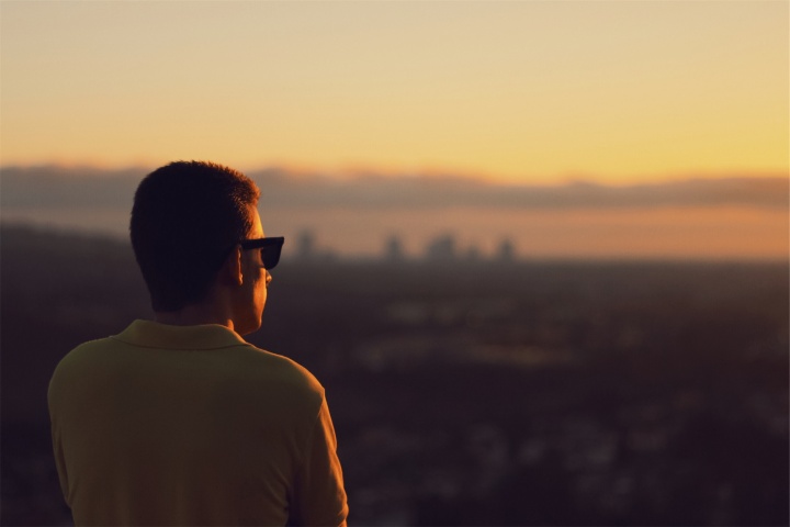 A man looking at a sunrise.