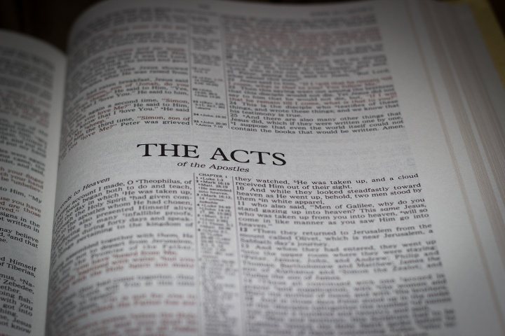 A Bible opened to the book of Acts.