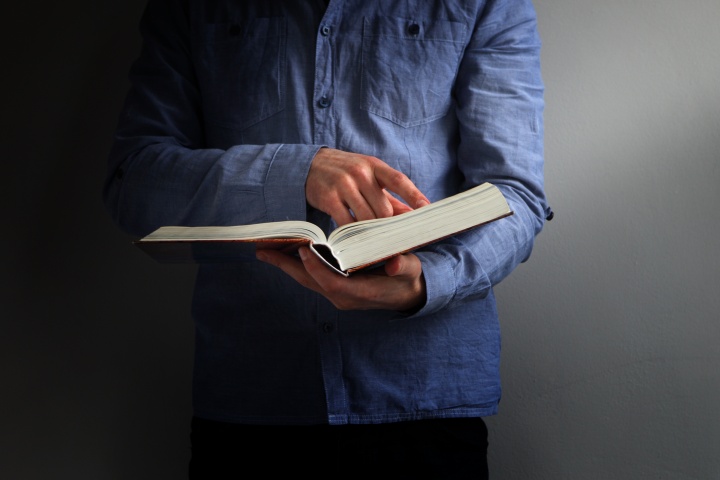 A person holding a Bible.