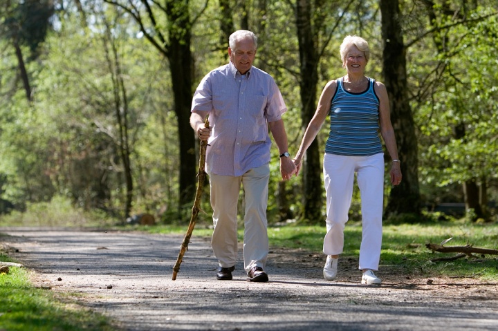 An elderly couple walking together.