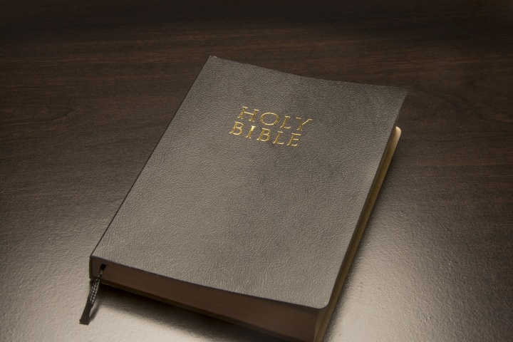 Bible laying on top of a table.