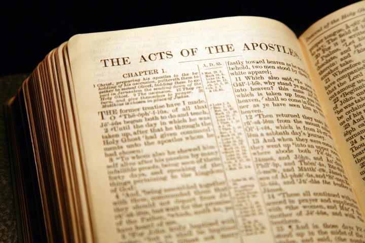 A Bible opened to the book of Acts.