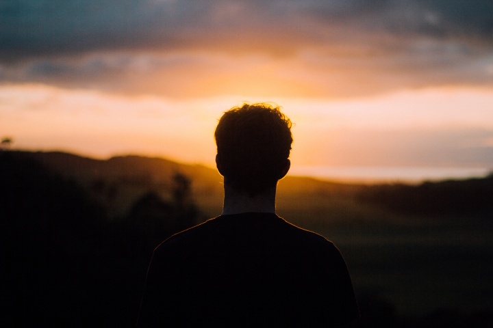 A person looking at a sunset.