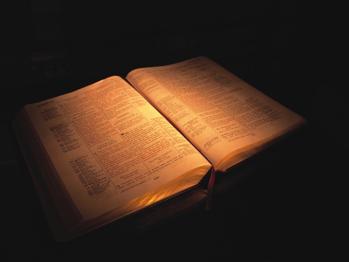 An older Bible open laying on a table.