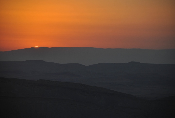 Sunset over desert hills.