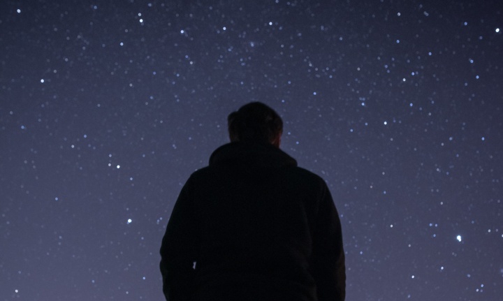 A young person looking up at the stars.