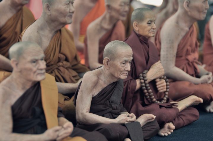 Buddhist monks sitting on the floor.