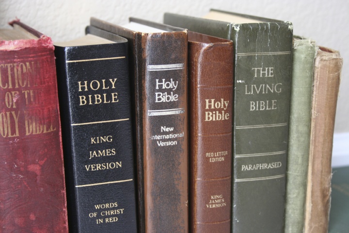 Various Bibles on a shelf.