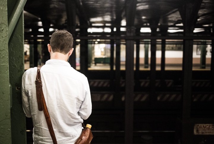 A man waiting at a subway station.