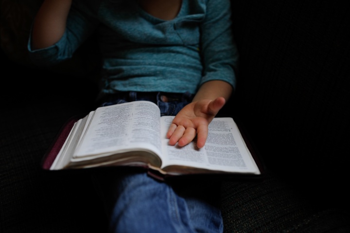 A person with a Bible on their lap.