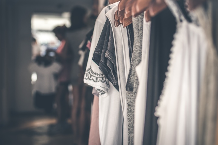 A woman going through a closet of clothes.