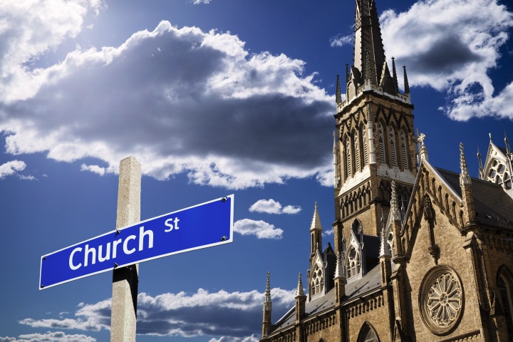 A church building with a street sign in front that says "Church Street".