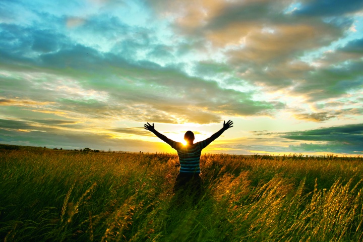 A person raising their hands to the sky.