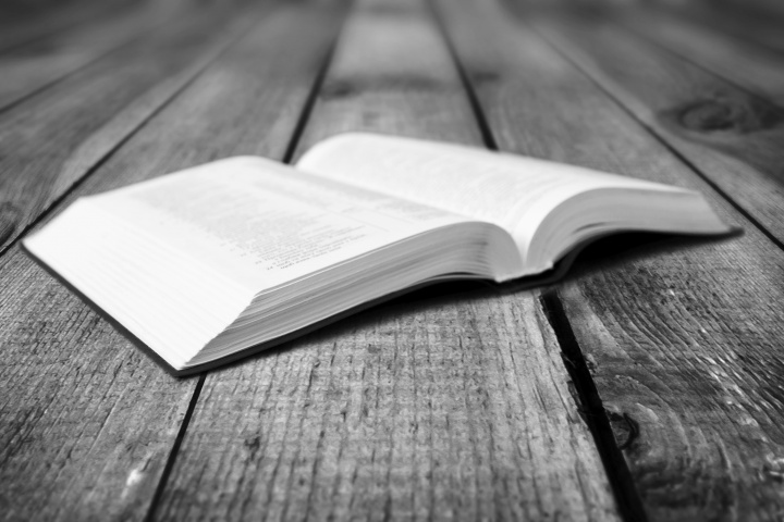 A open Bible laying on a table.