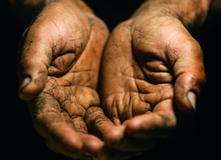 Old weathered hands cupped.