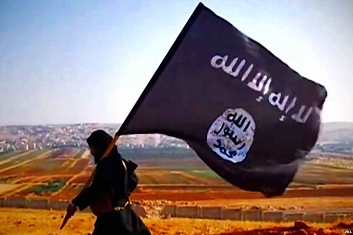 A man carrying a ISIS flag.
