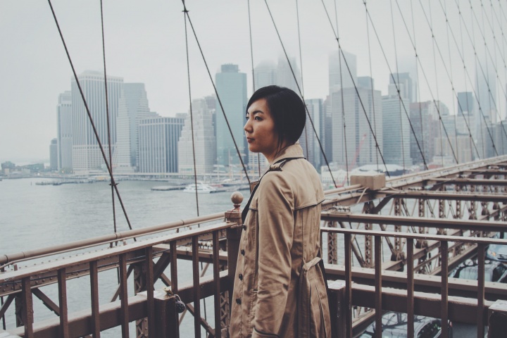 A woman walking on a bridge.