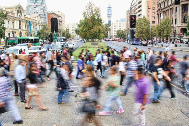A blur of crowded city sidewalk of people walking.