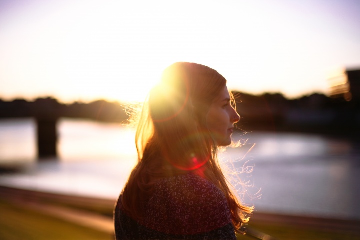 A woman with the sun reflecting through her hair.