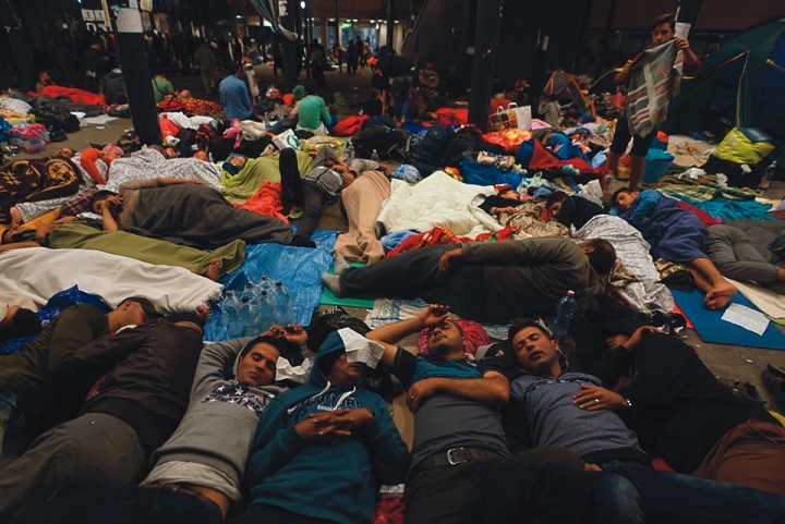 Syrian refugees sleep on the floor of a railway station in Hungary.