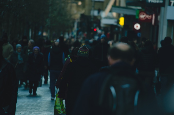 People walking on a crowded city street.