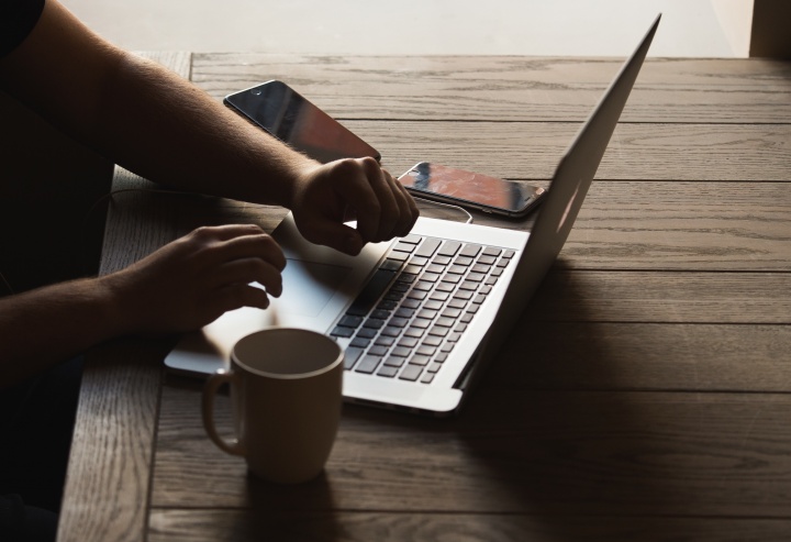 A person typing on a laptop.