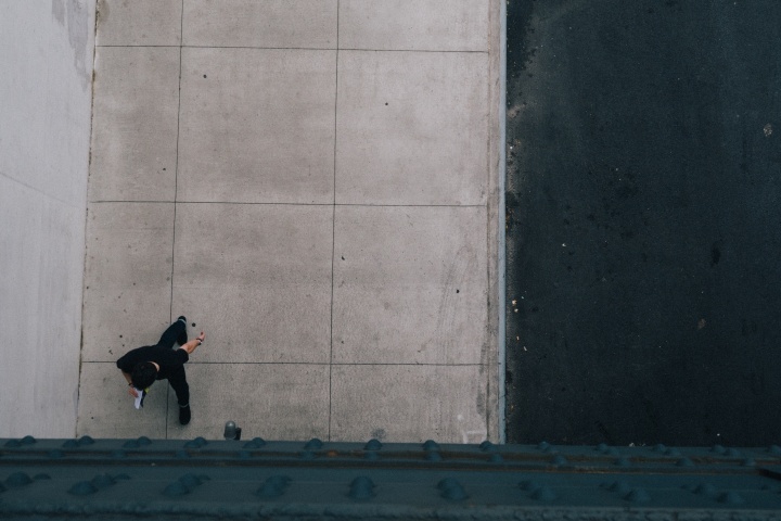 A man walking alone on a sidewalk.