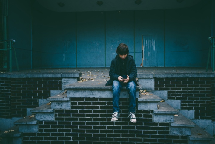 A young boy using a mobile device.