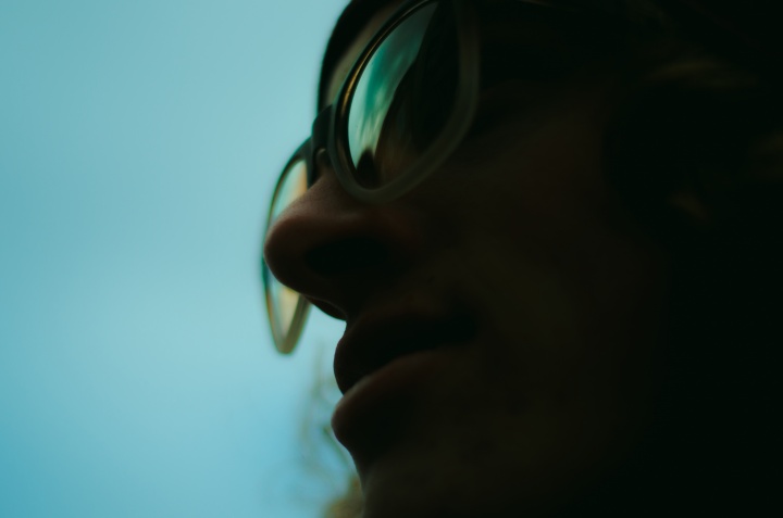 Upclose photo of a person wearing glasses.