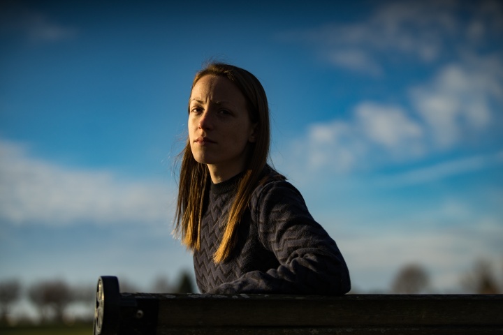 A young woman sitting on a bench.