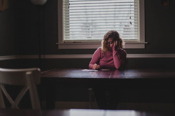 A woman sitting a table.