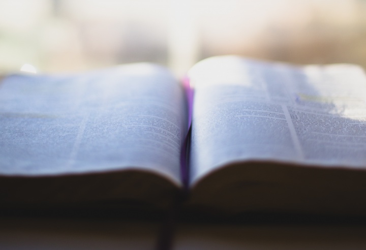 An open Bible laying on a table.