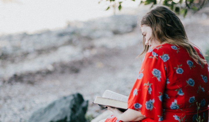 A woman reading a Bible.