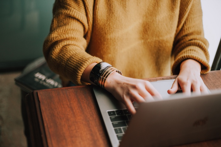 A woman typing on a laptop.