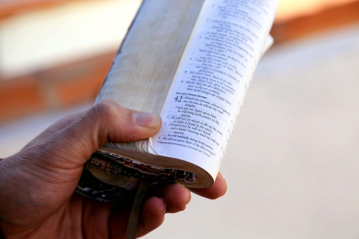 A man holding a Bible in his hand.