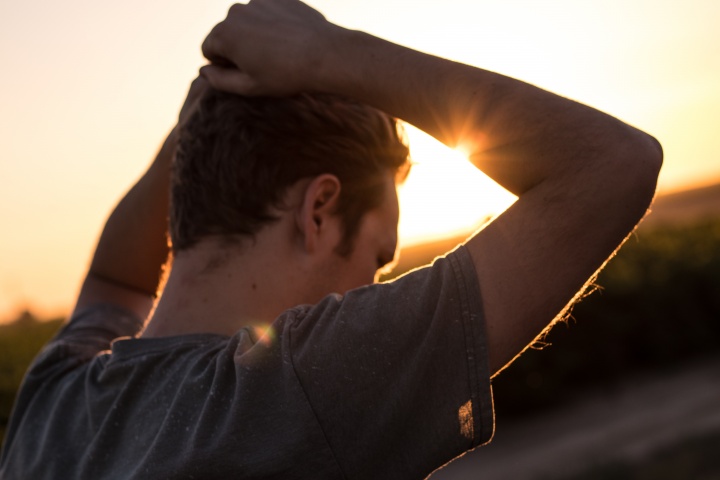 A man with his arms on his head.