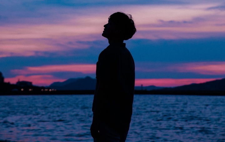 A silhouette of young man.