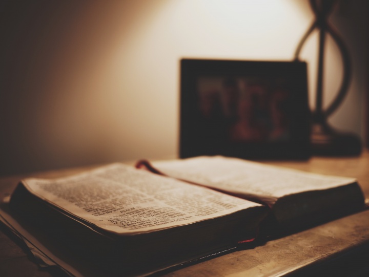 An open Bible laying on a table.