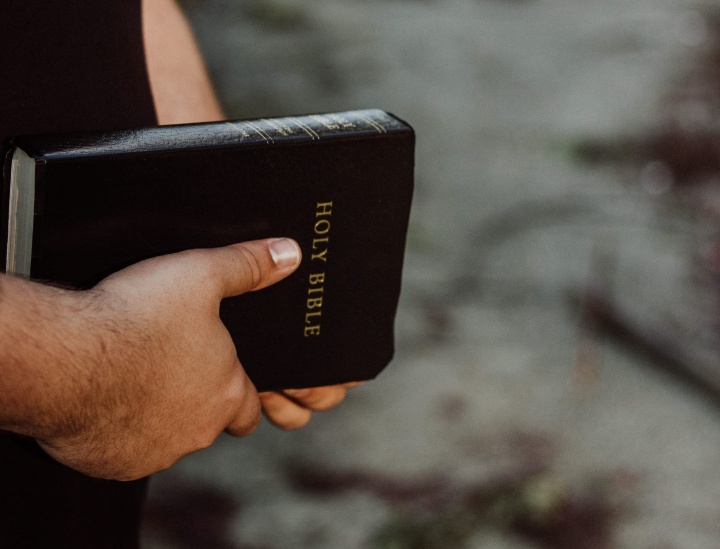 A man holding a Bible.