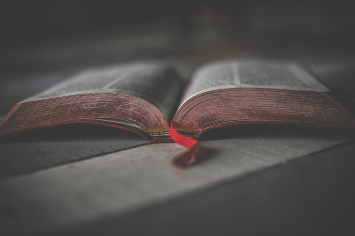 An open Bible laying on a table.