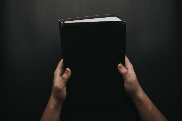 A person holding a Bible.