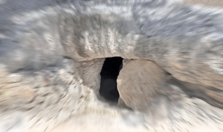 A tomb with round stone in the doorway.