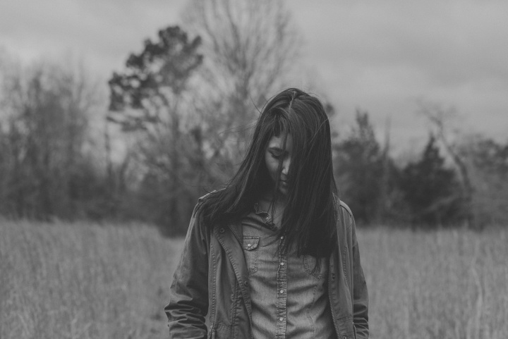 A woman walking in a field.