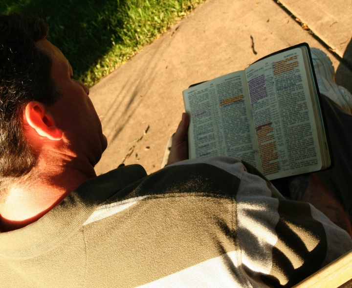 A man reading a Bible.