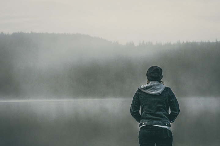 A person standing by a body of water.